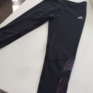 Black adidas pants, with colourful bottom pattern